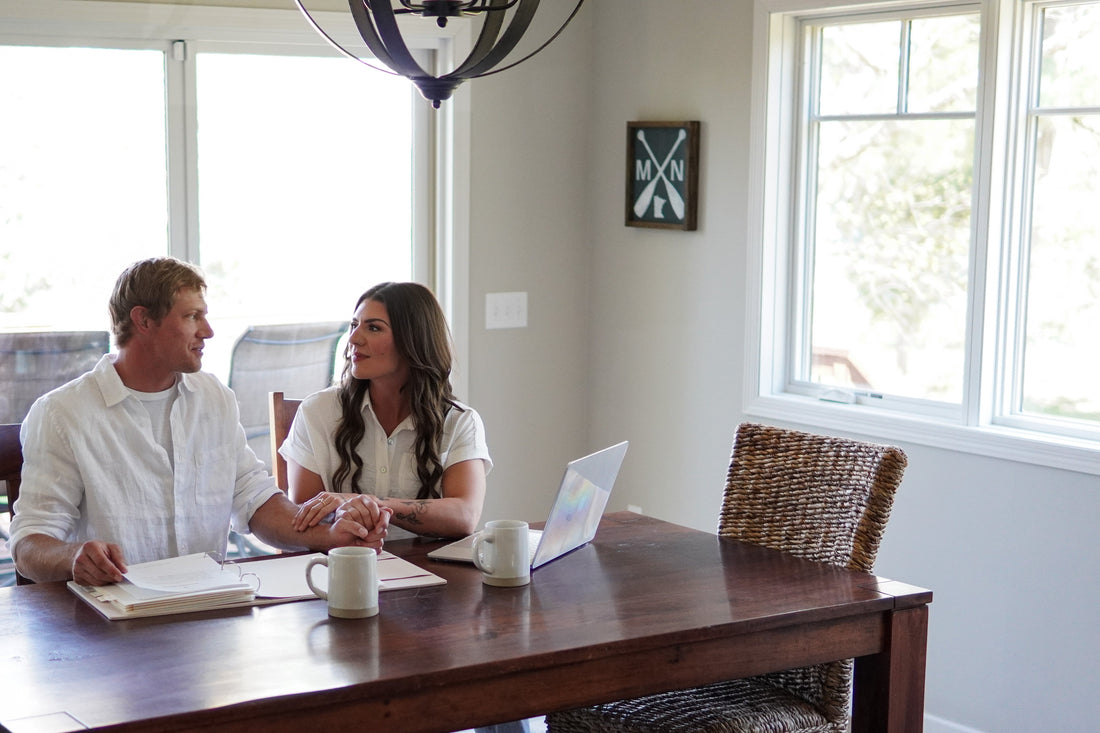 Newlywed updating bank, insurance, and government accounts with organized post-wedding documents in The Vow Vault
