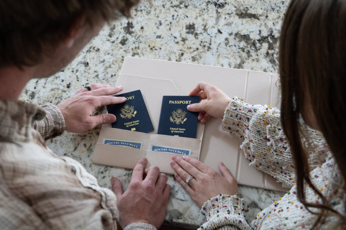 ewlywed couple reviewing their marriage certificate and organizing important post-wedding paperwork at home.
